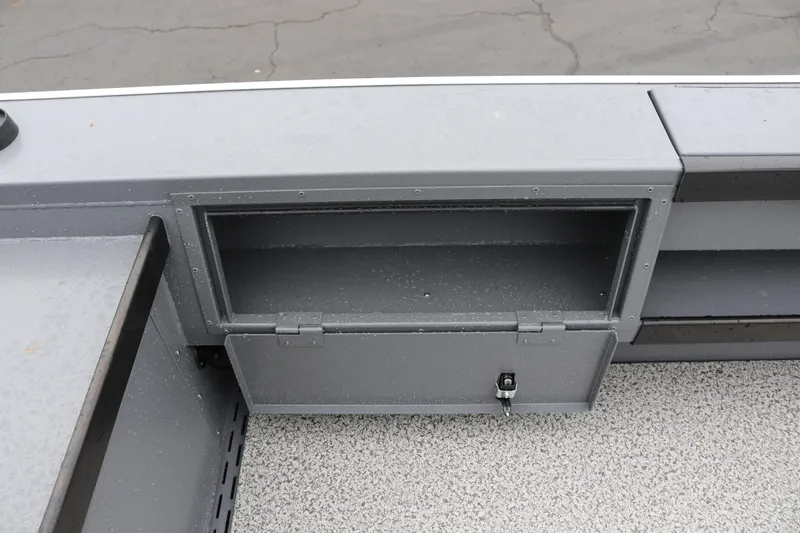 Slide: The Image of Storage compartment on 2026 Alumaweld Super Vee Pro 23 boat, featuring a secure latch. - 23