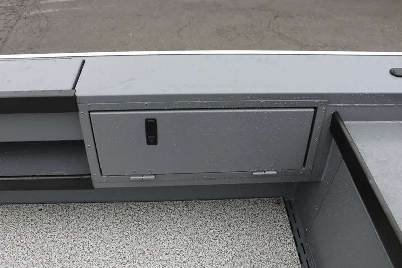 Slide: The Image of 2026 Alumaweld Super Vee Pro 23 boat interior storage compartment with sleek gray finish. - 24