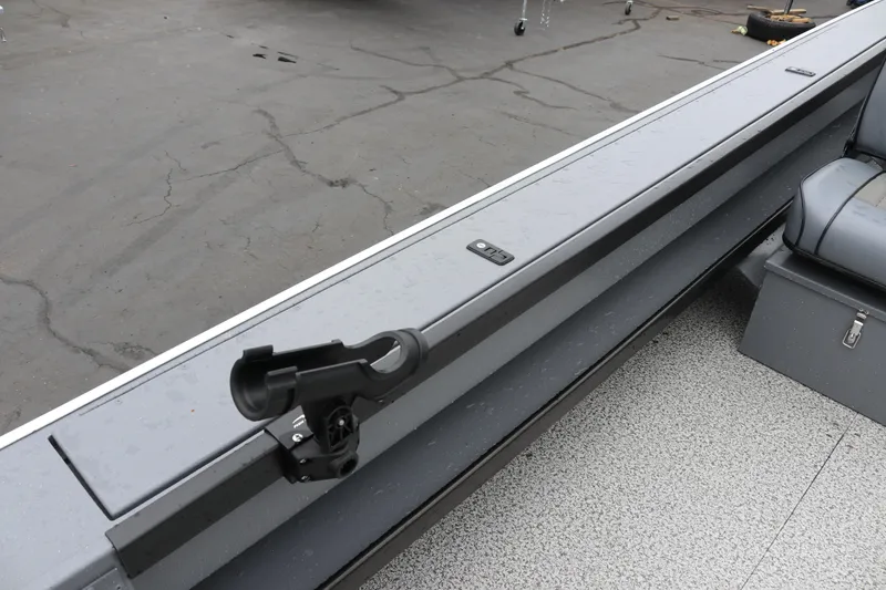 Slide: The Image of 2026 Alumaweld Super Vee Pro 23 boat interior with rod holder and seating. - 26