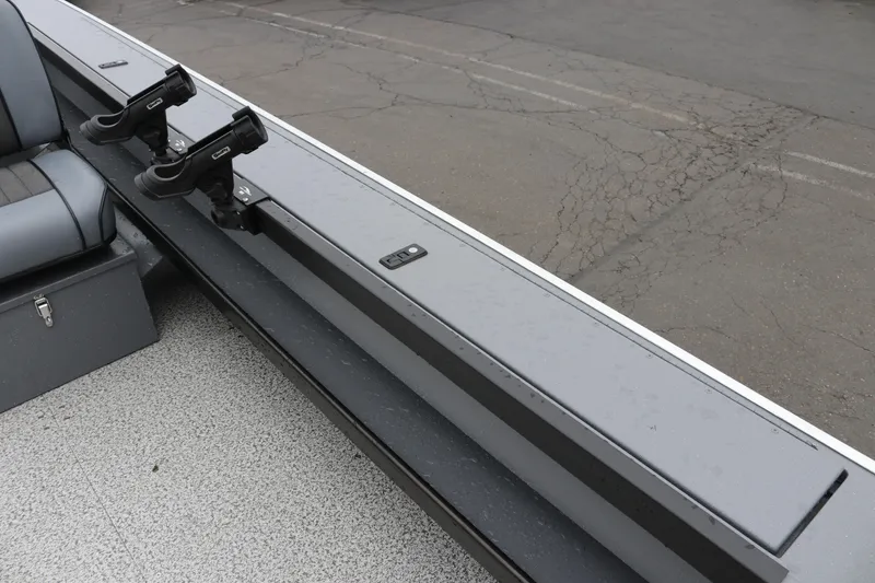 Slide: The Image of 2026 Alumaweld Super Vee Pro 23 boat interior with rod holders and seating. - 27