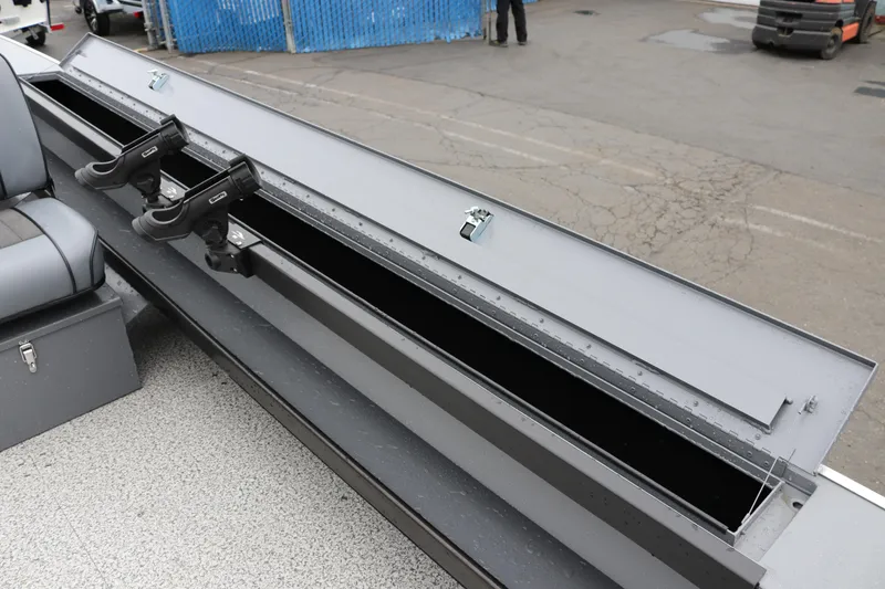 Slide: The Image of 2026 Alumaweld Super Vee Pro 23 boat storage compartment with rod holders and seating. - 28