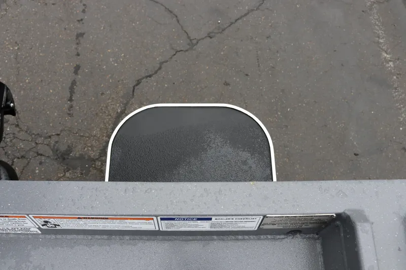 Slide: The Image of Alumaweld Super Vee Pro 23 boat step detail, 2026 model, on wet pavement. - 29