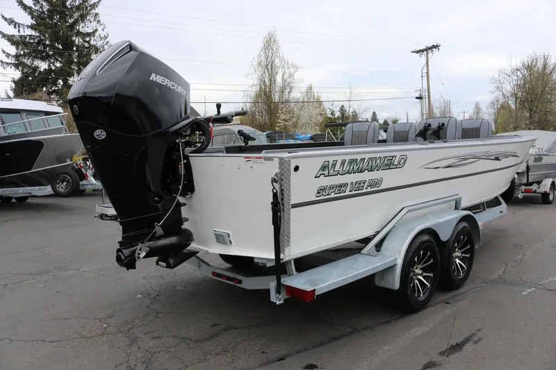 Slide: The Image of 2026 Alumaweld Super Vee Pro 23 boat with Mercury outboard motor on trailer. - 3