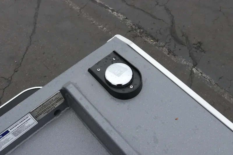 Slide: The Image of Fuel cap on 2026 Alumaweld Super Vee Pro 23 boat, gray surface, outdoor setting. - 30