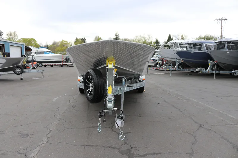 Slide: The Image of 2026 Alumaweld Super Vee Pro 23 boat on trailer in parking lot. - 4