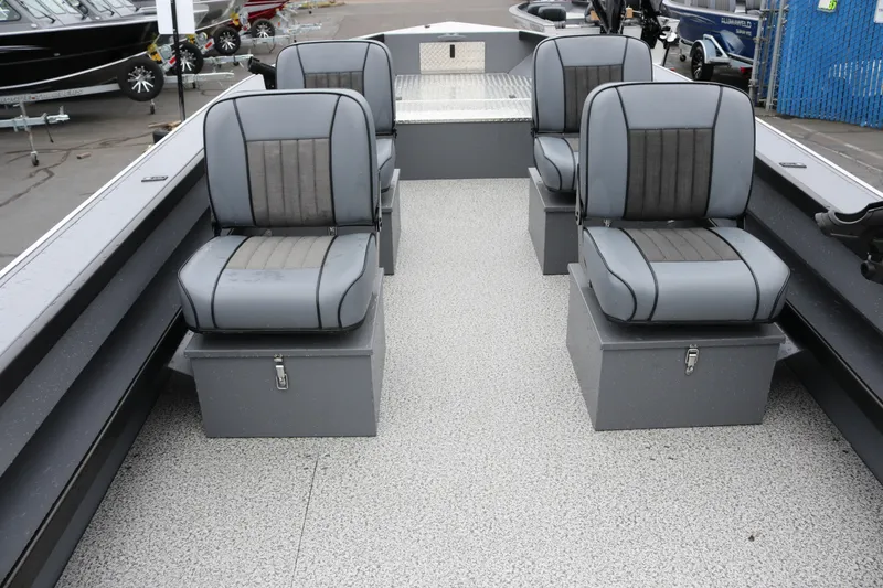 Slide: The Image of 2026 Alumaweld Super Vee Pro 23 boat interior with four gray seats. - 8