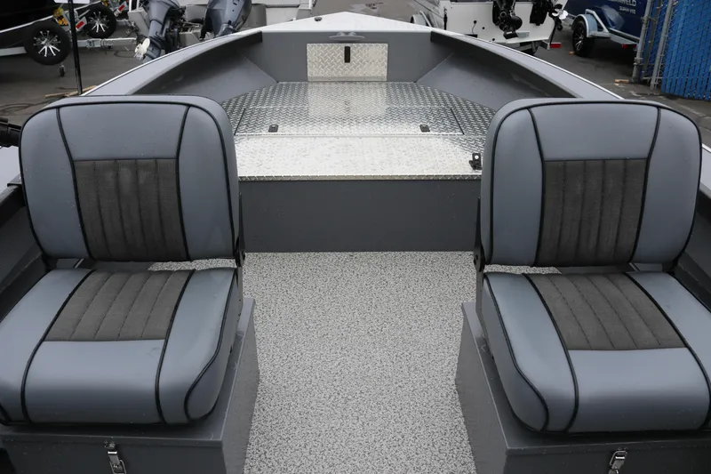 Slide: The Image of 2026 Alumaweld Super Vee Pro 23 interior with two gray seats and textured flooring. - 9