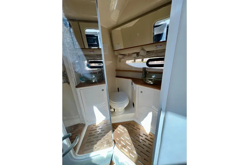 Slide: The Image of Interior of 2017 Sea Ray Sundancer 350 Coupe bathroom with modern fixtures and wooden accents. - 100