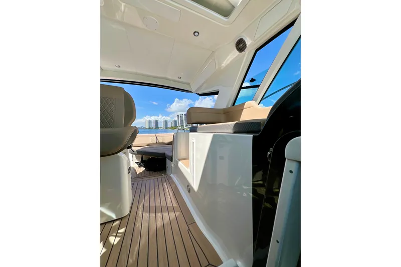 Slide: The Image of Interior view of 2017 Sea Ray Sundancer 350 Coupe with modern seating and ocean backdrop. - 101