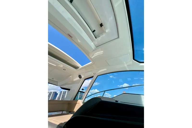Slide: The Image of Interior view of 2017 Sea Ray Sundancer 350 Coupe with sunroof and blue sky. - 102