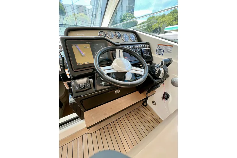 Slide: The Image of Cockpit of 2017 Sea Ray Sundancer 350 Coupe with navigation display and steering wheel. - 113