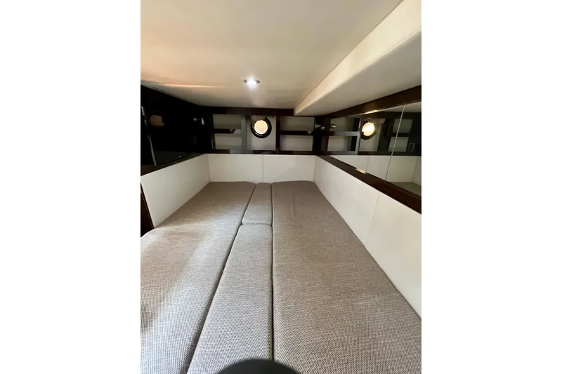 Slide: The Image of 2017 Sea Ray Sundancer 350 Coupe cabin interior with twin beds and porthole window. - 117