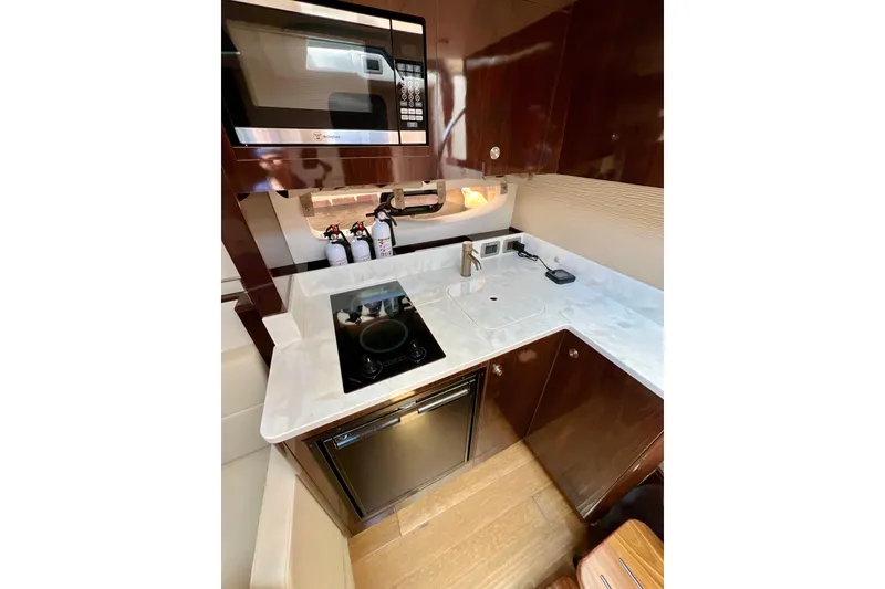 Slide: The Image of 2017 Sea Ray Sundancer 350 Coupe kitchen with modern appliances and sleek cabinetry. - 120
