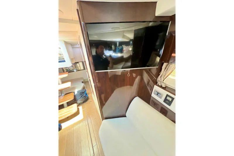 Slide: The Image of Interior of 2017 Sea Ray Sundancer 350 Coupe with TV and seating area. - 123