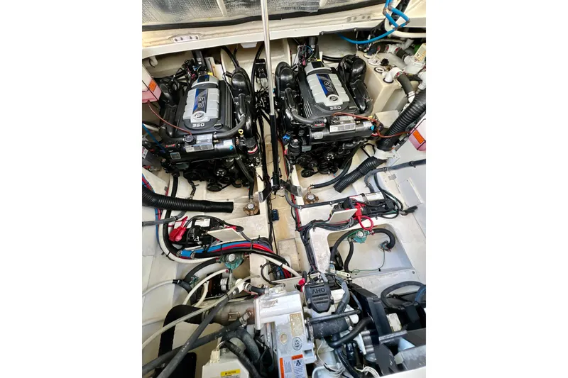 Slide: The Image of Engine compartment of a 2017 Sea Ray Sundancer 350 Coupe, showcasing dual engines and wiring. - 128