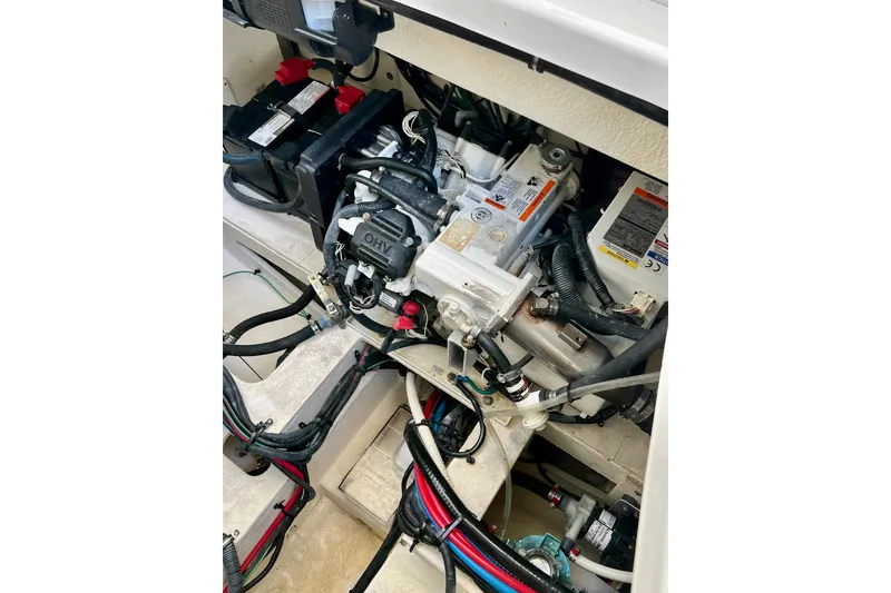 Slide: The Image of Engine compartment of a 2017 Sea Ray Sundancer 350 Coupe with visible wiring and components. - 131