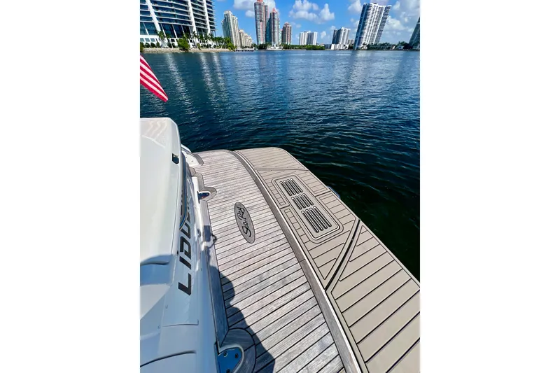 Slide: The Image of 2017 Sea Ray Sundancer 350 Coupe on water, city skyline in background. - 19