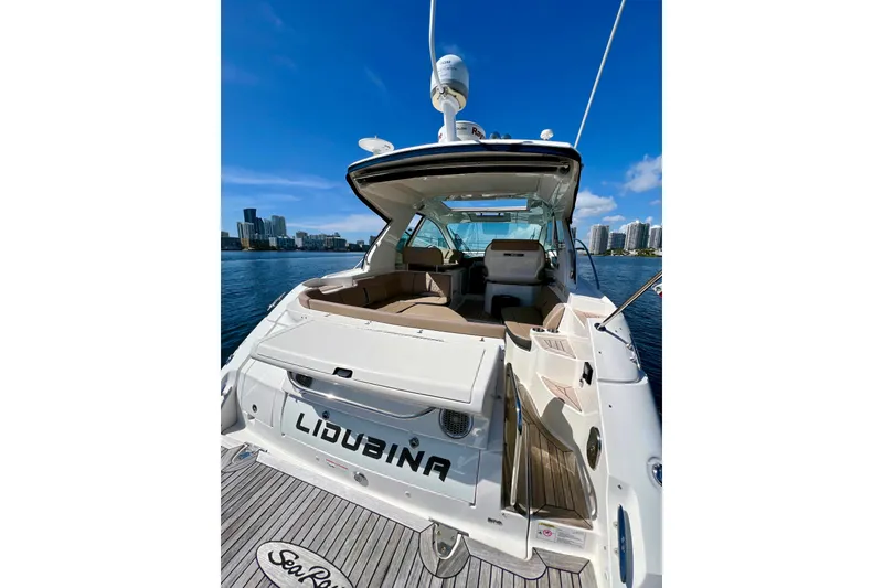 Slide: The Image of 2017 Sea Ray Sundancer 350 Coupe yacht docked with city skyline in background. - 21