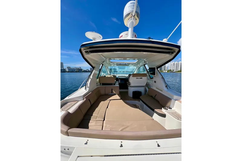 Slide: The Image of 2017 Sea Ray Sundancer 350 Coupe with spacious seating, docked on a sunny day. - 23