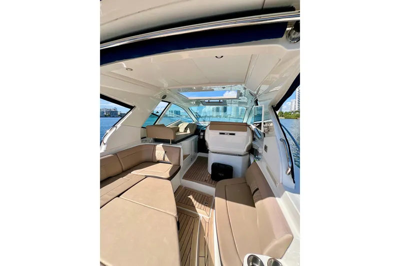 Slide: The Image of 2017 Sea Ray Sundancer 350 Coupe interior with beige seating and panoramic windows. - 27