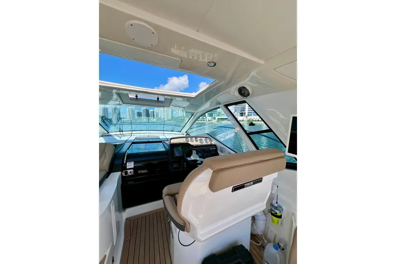 Slide: The Image of Interior view of 2017 Sea Ray Sundancer 350 Coupe helm with cityscape background. - 30