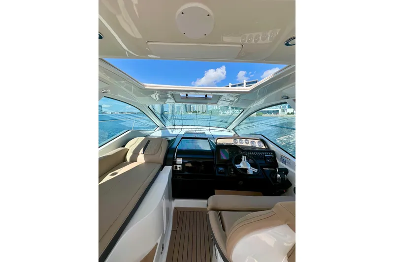 Slide: The Image of Interior view of 2017 Sea Ray Sundancer 350 Coupe yacht cockpit with waterfront backdrop. - 32