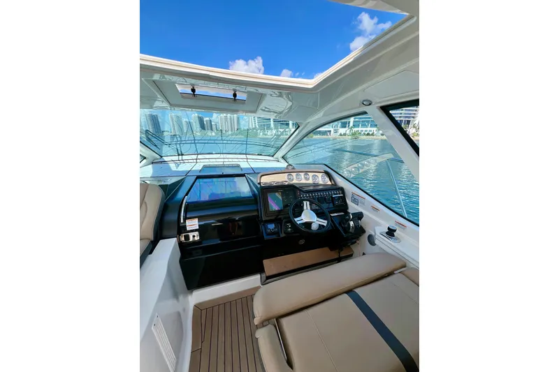 Slide: The Image of 2017 Sea Ray Sundancer 350 Coupe cockpit with modern navigation system and waterfront view. - 33