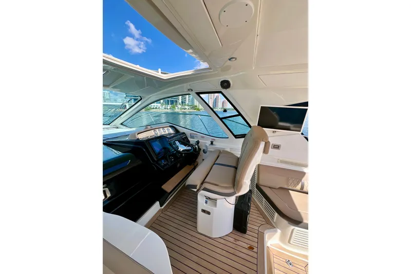 Slide: The Image of Interior of 2017 Sea Ray Sundancer 350 Coupe with modern helm and waterfront view. - 34