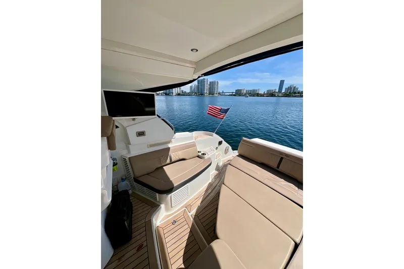Slide: The Image of 2017 Sea Ray Sundancer 350 Coupe interior with waterfront view and American flag. - 35