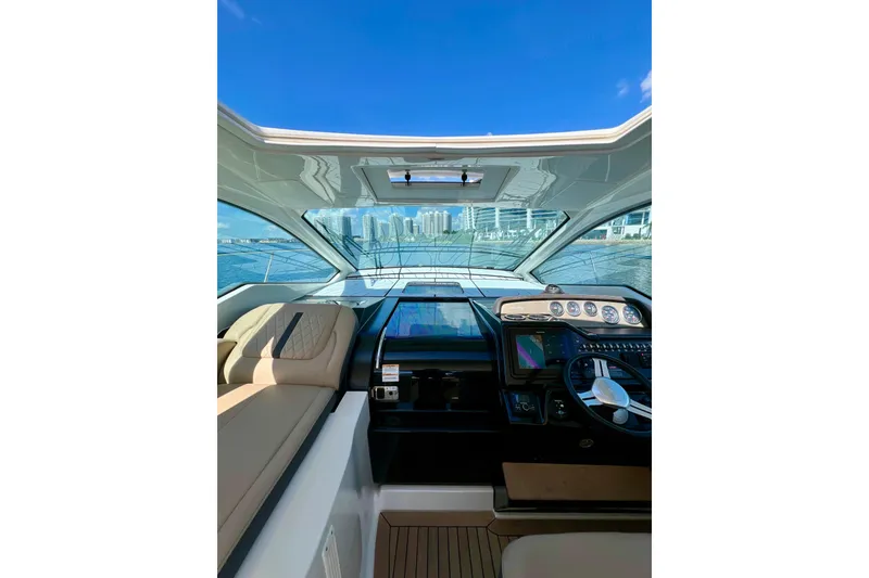 Slide: The Image of Interior view of 2017 Sea Ray Sundancer 350 Coupe helm with city skyline. - 36