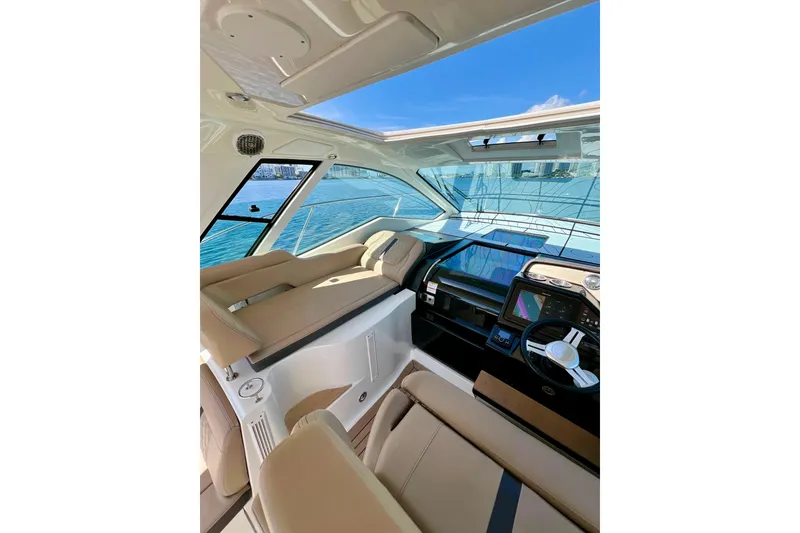 Slide: The Image of Interior view of 2017 Sea Ray Sundancer 350 Coupe, featuring modern helm and seating. - 39