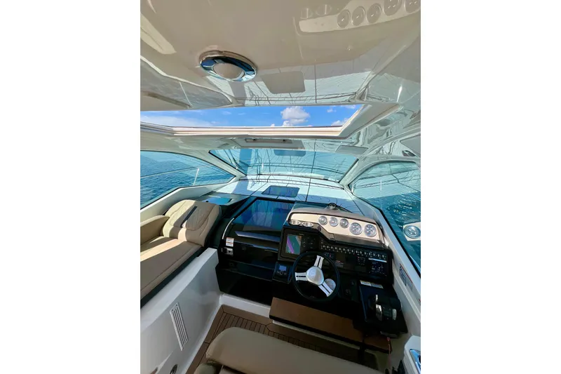Slide: The Image of 2017 Sea Ray Sundancer 350 Coupe cockpit with modern controls and ocean view. - 40