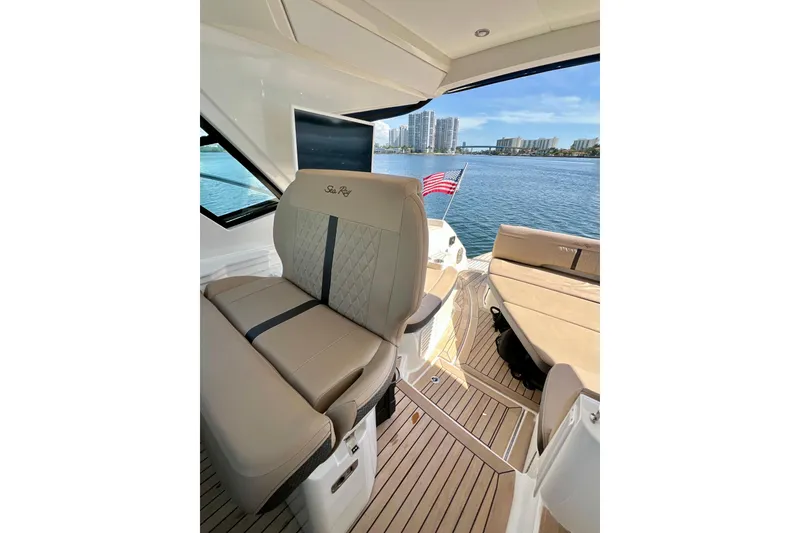 Slide: The Image of 2017 Sea Ray Sundancer 350 Coupe interior with waterfront view and American flag. - 42