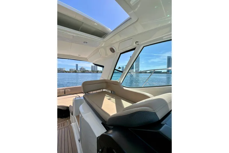 Slide: The Image of 2017 Sea Ray Sundancer 350 Coupe interior with city skyline view through windows. - 45