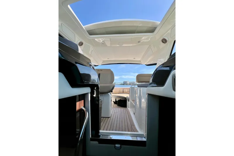 Slide: The Image of Interior view of 2017 Sea Ray Sundancer 350 Coupe, showcasing sleek design and open skyroof. - 47