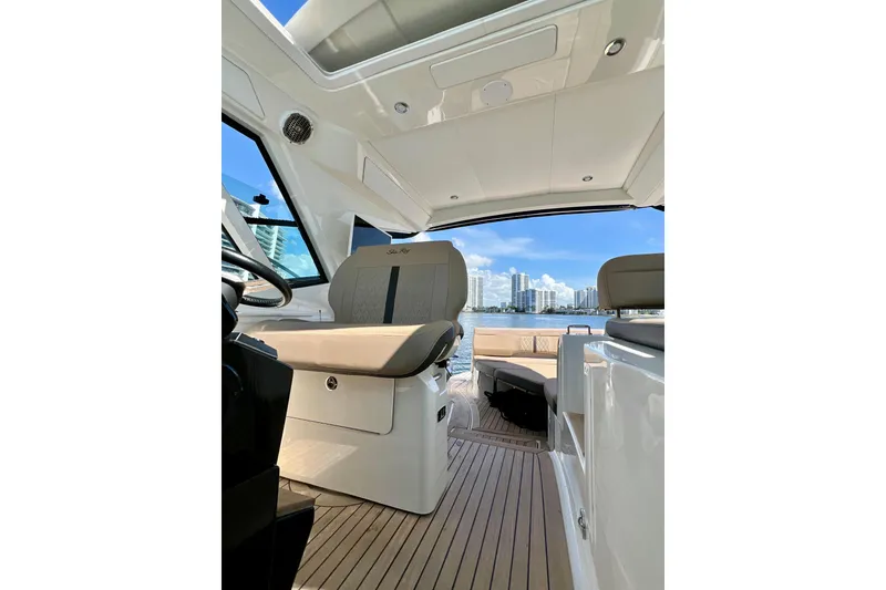 Slide: The Image of Interior view of 2017 Sea Ray Sundancer 350 Coupe with city skyline in background. - 49