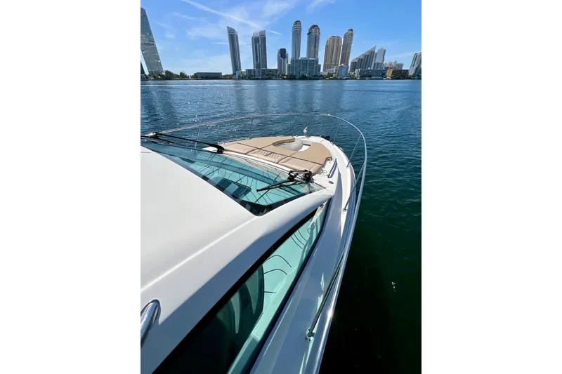 Slide: The Image of 2017 Sea Ray Sundancer 350 Coupe on water with city skyline in background. - 55