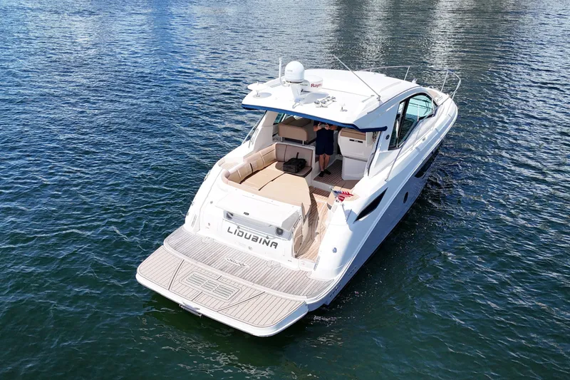 Slide: The Image of 2017 Sea Ray Sundancer 350 Coupe cruising on calm waters. - 6