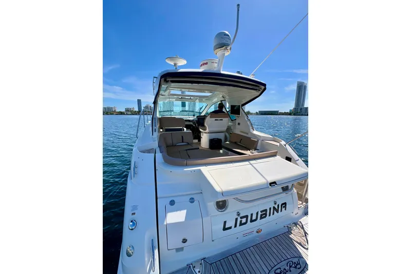 Slide: The Image of 2017 Sea Ray Sundancer 350 Coupe yacht docked, featuring spacious seating and modern design. - 61
