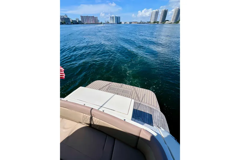 Slide: The Image of 2017 Sea Ray Sundancer 350 Coupe on water, city skyline in background. - 69