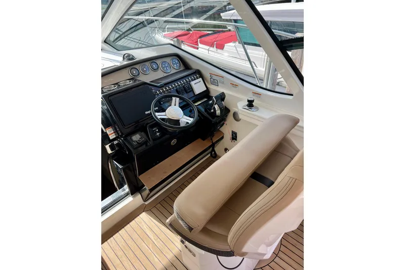 Slide: The Image of 2017 Sea Ray Sundancer 350 Coupe helm with modern controls and beige seating. - 72