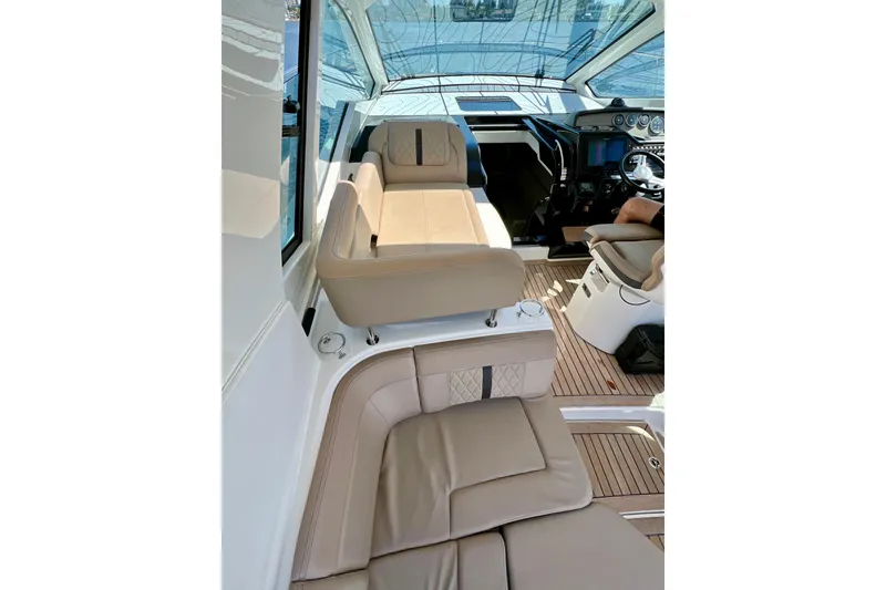 Slide: The Image of Interior of 2017 Sea Ray Sundancer 350 Coupe with beige seating and helm. - 75
