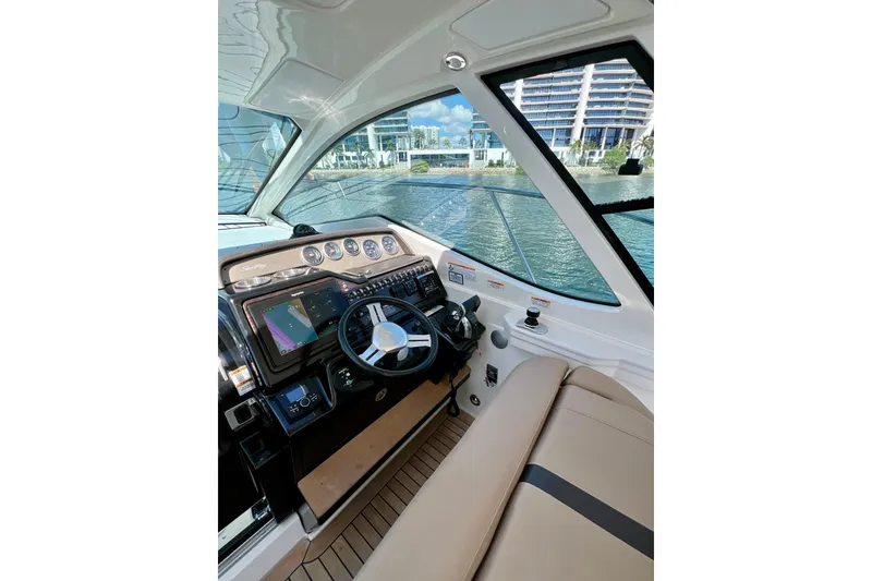 Slide: The Image of Interior view of 2017 Sea Ray Sundancer 350 Coupe helm with modern controls. - 77