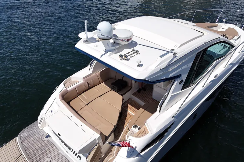 Slide: The Image of 2017 Sea Ray Sundancer 350 Coupe yacht on water, featuring spacious deck and modern design. - 8