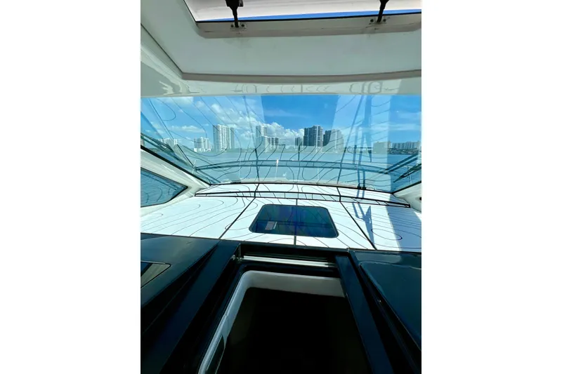 Slide: The Image of Interior view from a 2017 Sea Ray Sundancer 350 Coupe, overlooking a city skyline. - 84