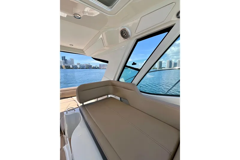 Slide: The Image of 2017 Sea Ray Sundancer 350 Coupe interior with city skyline view through windows. - 87
