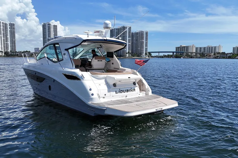 Slide: The Image of 2017 Sea Ray Sundancer 350 Coupe cruising on a sunny day near city skyline. - 9