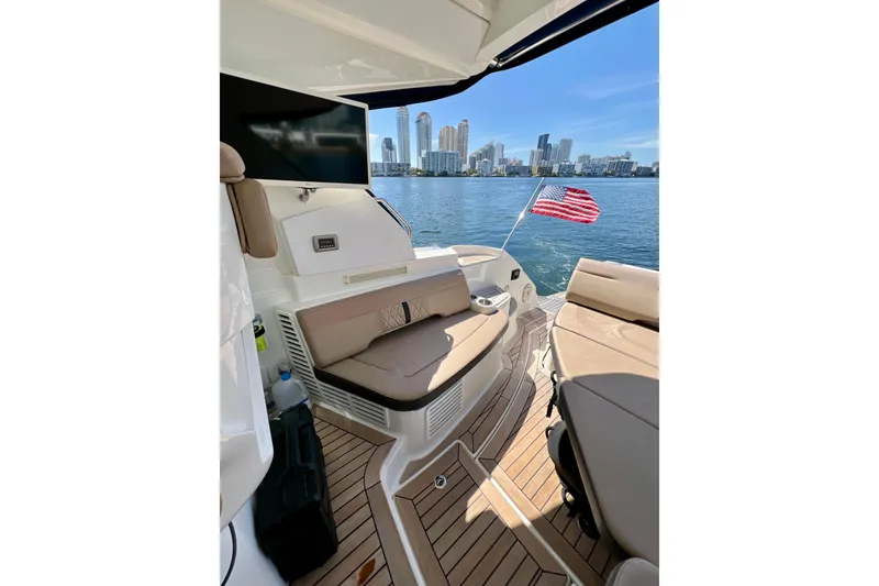 Slide: The Image of 2017 Sea Ray Sundancer 350 Coupe interior with city skyline and American flag. - 90