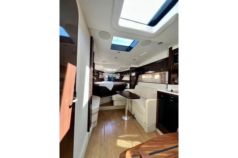 Slide: The Image of Interior of 2017 Sea Ray Sundancer 350 Coupe, featuring elegant seating and skylight. - 92