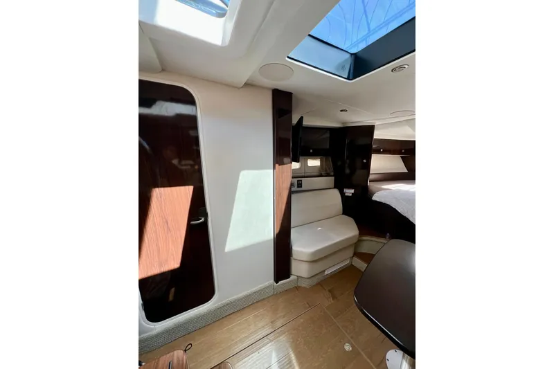 Slide: The Image of Interior of 2017 Sea Ray Sundancer 350 Coupe, featuring modern seating and skylight. - 98